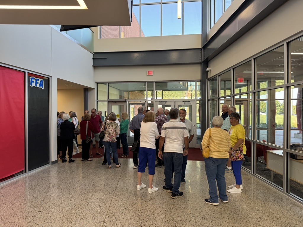 members gathered in the entry way into ths