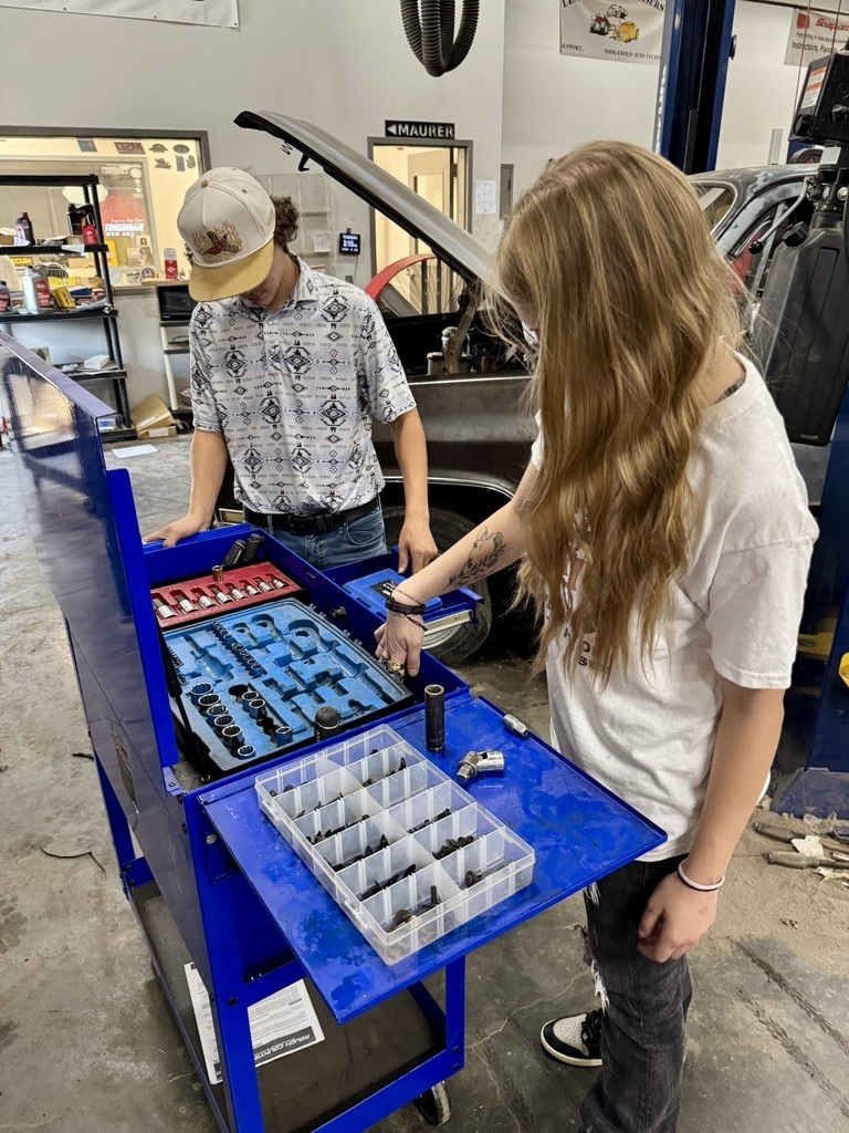 two high school students organize ratchet heads in a blue toolbox