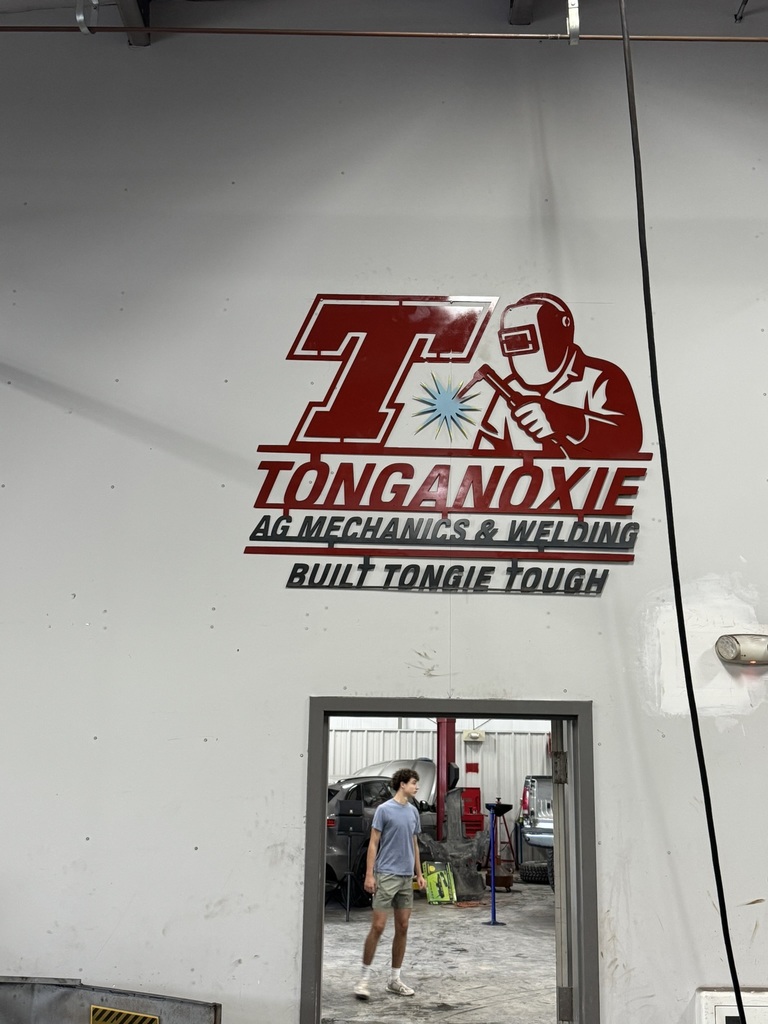welded metal red and black sign that says Tonganoxie Ag Mechanics and Welding Built Tongie Tough