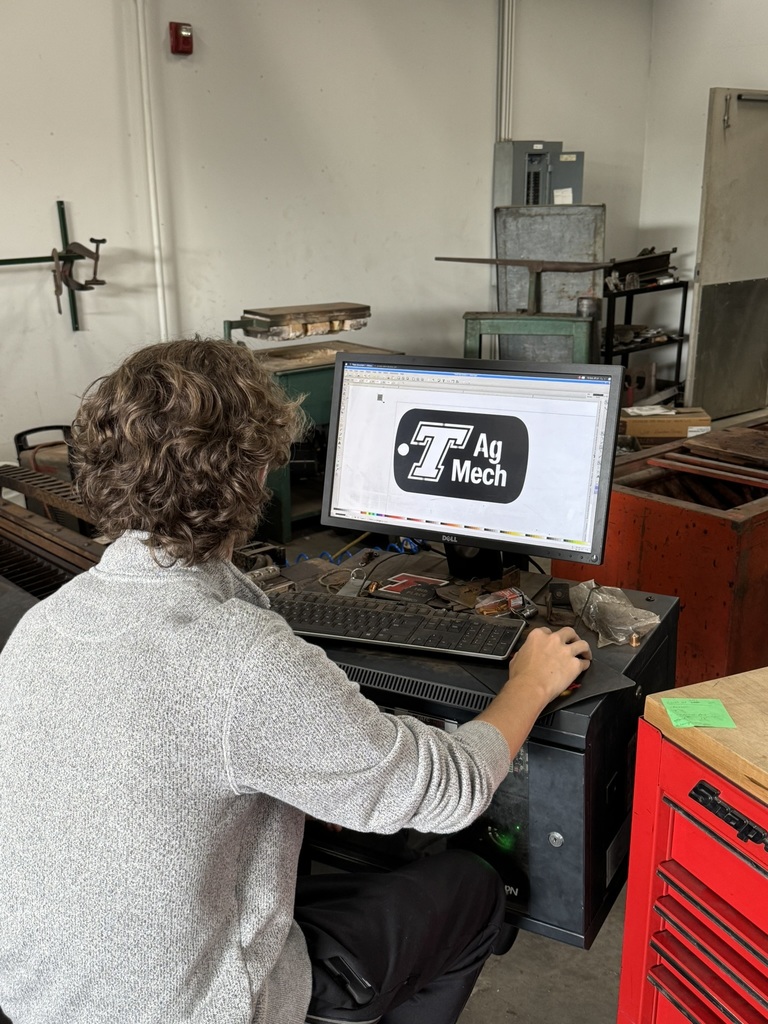 student designing ag mech logo on computer