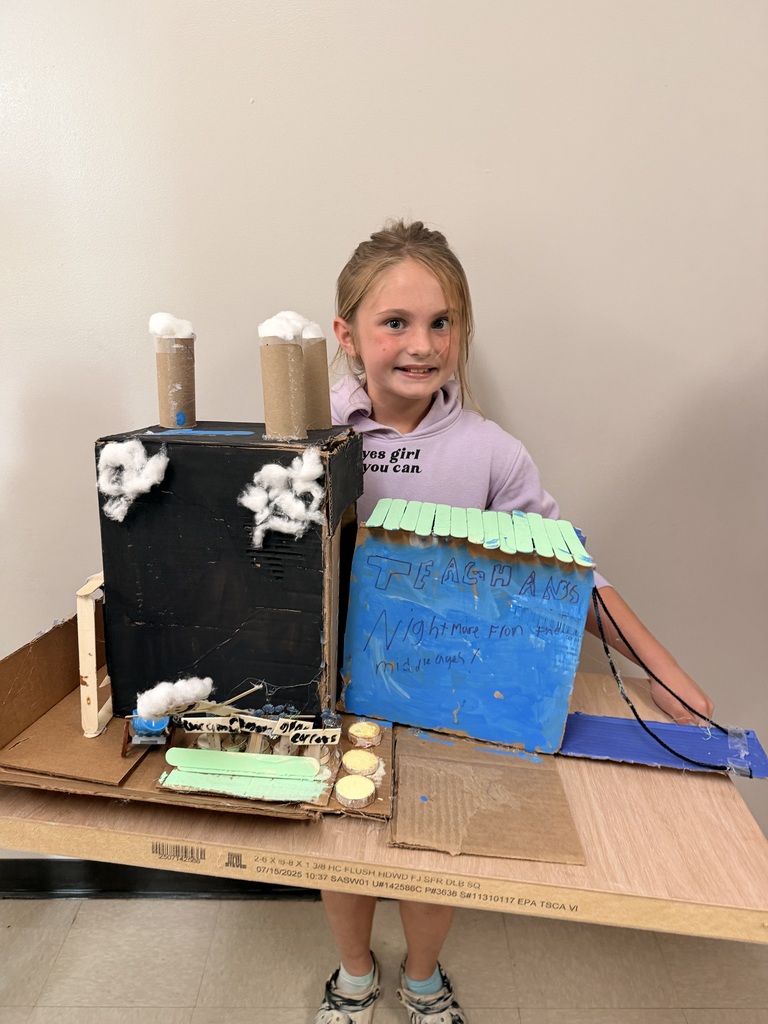 Teaghan Brown in Miss. Shea's 4th grade class with her medieval castle.