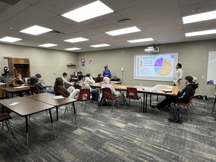 Debbie and Diego from First State Bank and Trust presenting about financial topics to Success Center Students