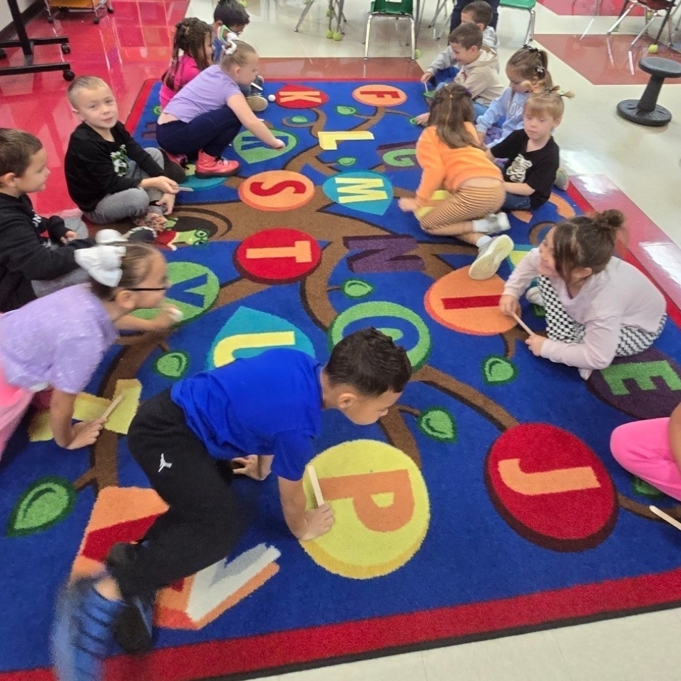 Mrs. Brice's Kindergarten class is learning about pushes and pulls in science. Pictured they are working with a partner on pushing a ping pong ball with more force and less force. 