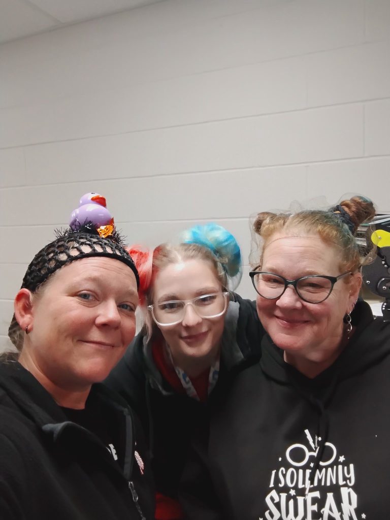three women wearing black shirts and crazy hair