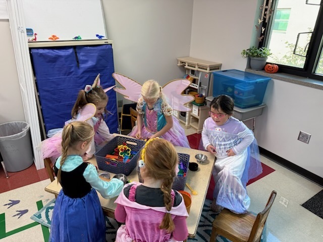 Kindergarten students in costumes celebrating Halloween. 