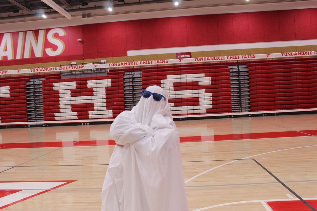 student wearing a sheet like a ghost in the THS gym