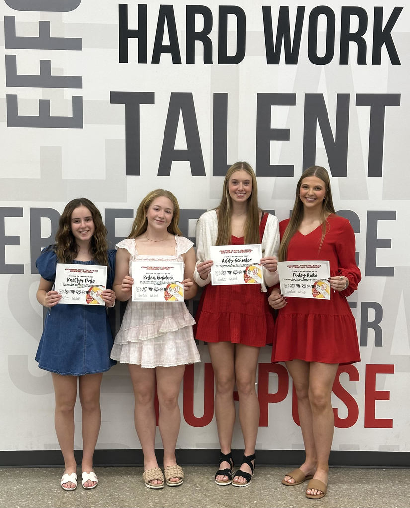 four female high school volleyball players wearing dresses and holding white certificates