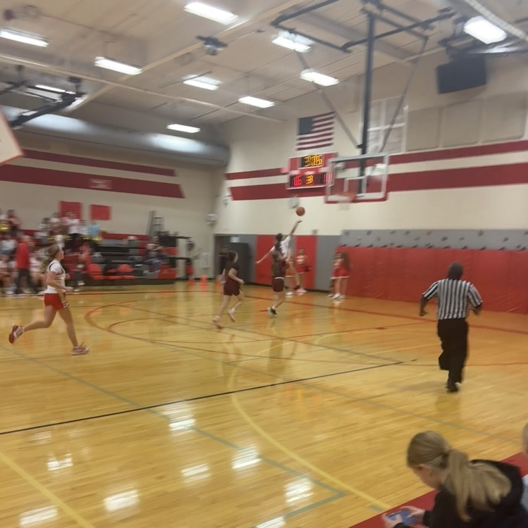 girls with basketball run down court and lays it up.