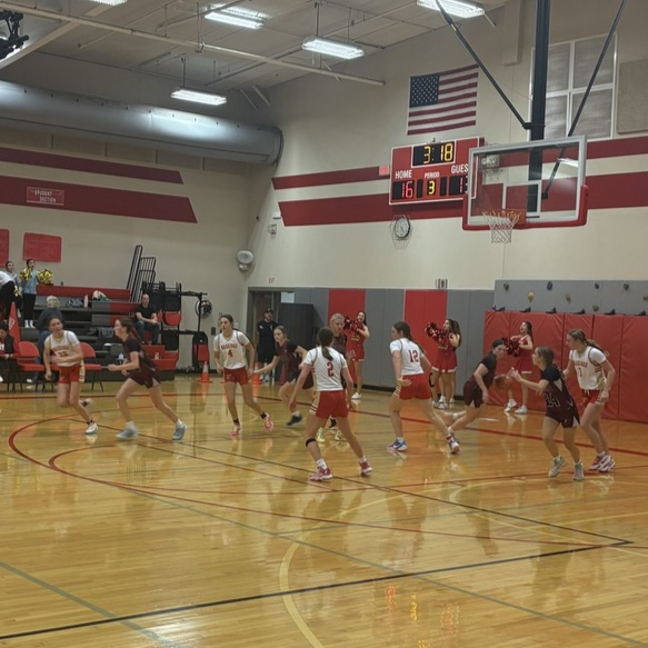 girls in white jersey playing basketball.