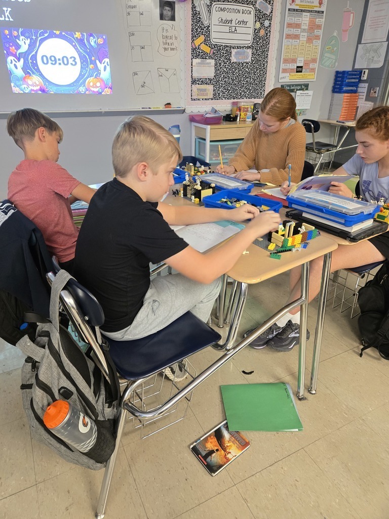 seventh grade students sitting at desks writing
