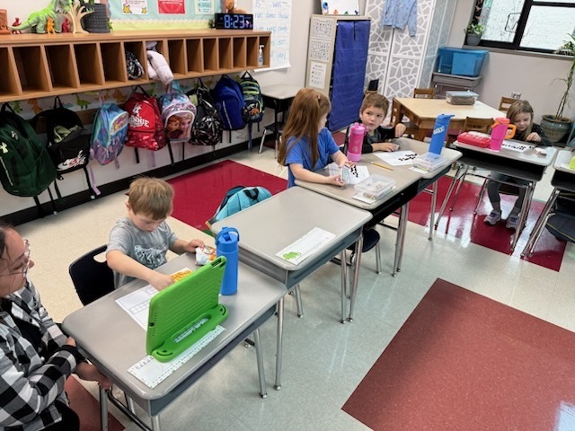 Students working on filling ten frames with 67 gold fish. 
