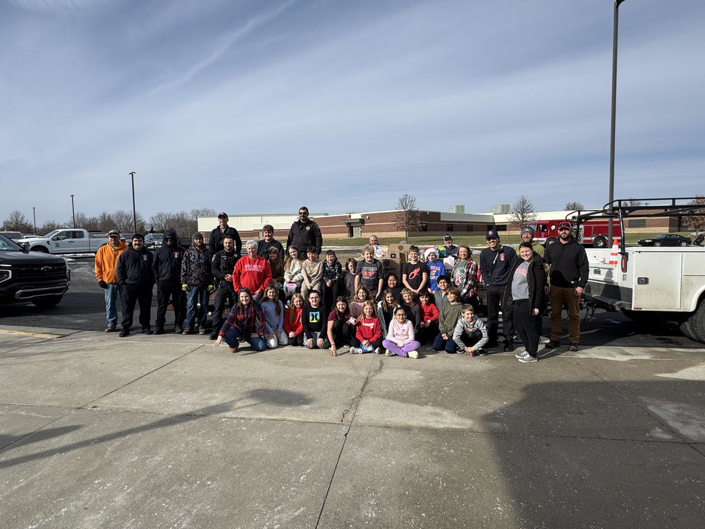 Mrs. Schaecher's class and community leaders loading up canned goods.