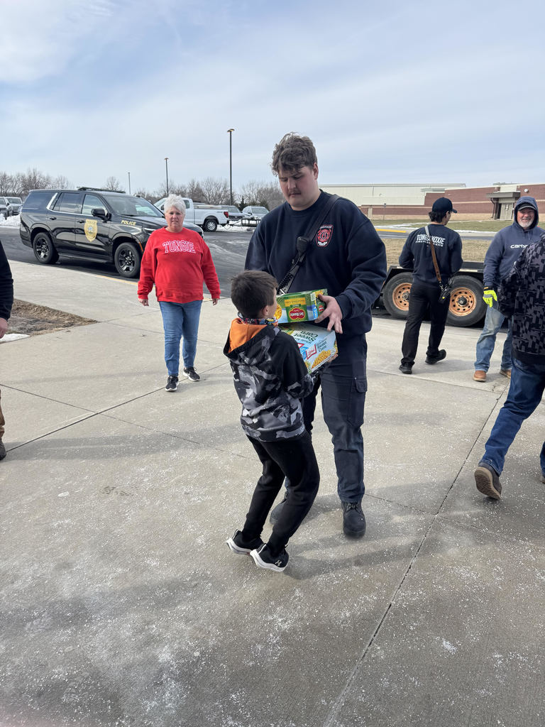 Mrs. Schaecher's class and community leaders loading up canned goods.