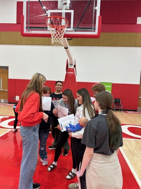 Students learn about what car they can purchase at the transportation table