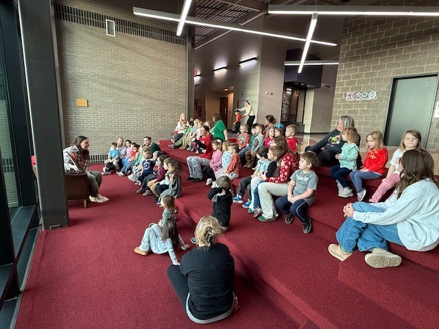 Preschools enjoying some story and music time from Ms. Katie. Ms. Katie works at Tonganoxie Library and enjoys story and music time once a month with our preschoolers.