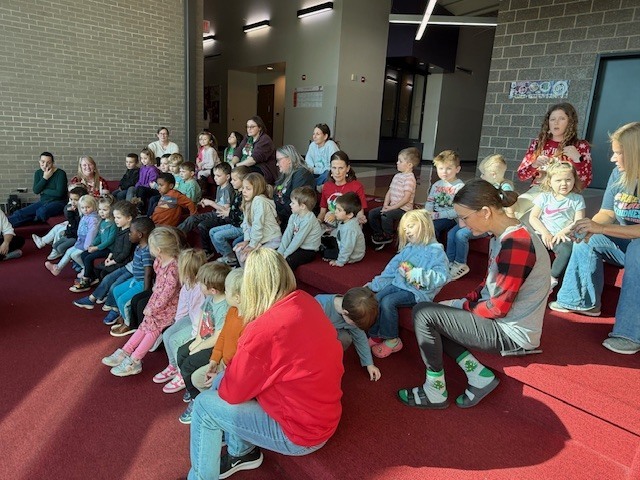 Preschools enjoying some story and music time from Ms. Katie. Ms. Katie works at Tonganoxie Library and enjoys story and music time once a month with our preschoolers.
