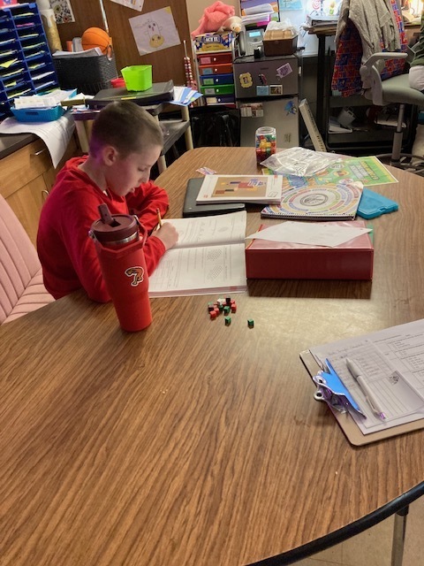 Students in Mrs. Maize's math class use math manipulatives to create a conceptual understanding of finding the volume of a rectangular prism.