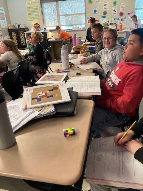 Students in Mrs. Maize's math class use math manipulatives to create a conceptual understanding of finding the volume of a rectangular prism.