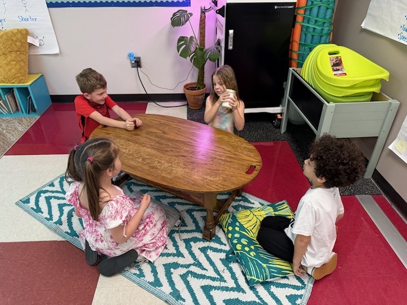 Students using a jar to make butter.