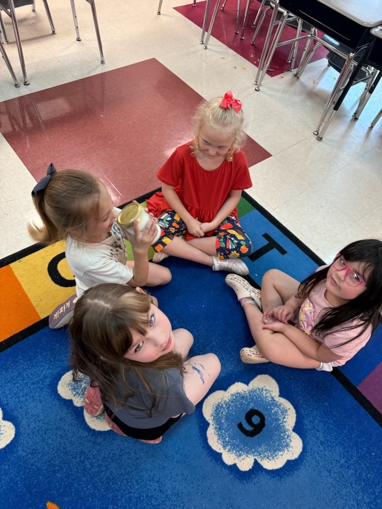 Students using a jar to make butter.