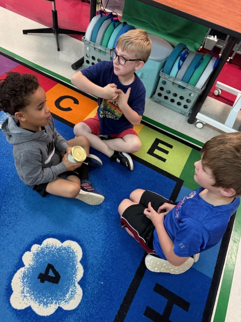 Students using a jar to make butter.