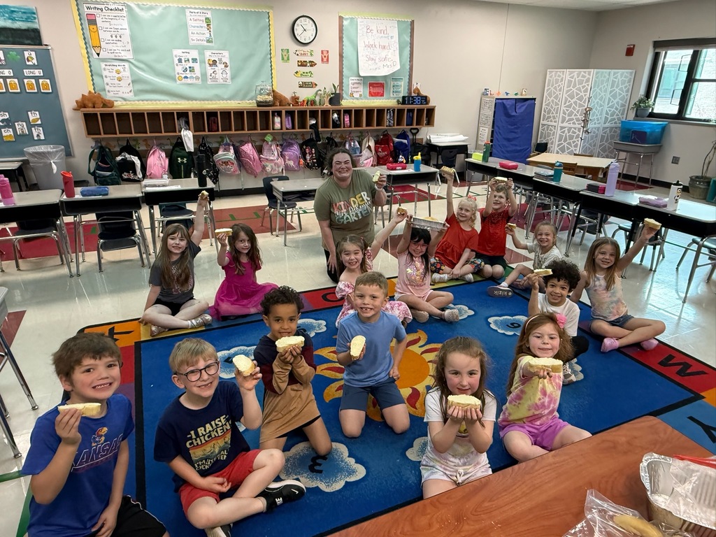 Students showing off their homemade bread and butter.