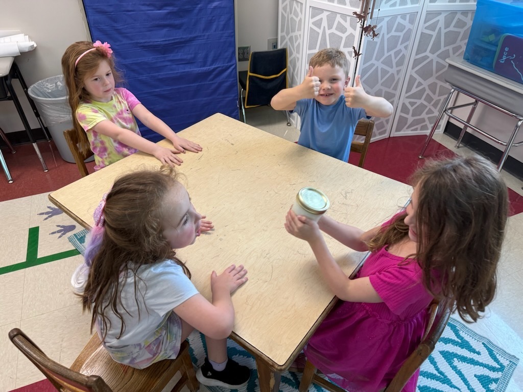 Students using a jar to make butter.