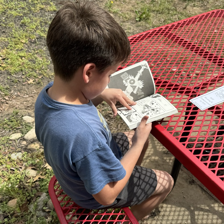 Mrs. Olsen’s class reading outside.
