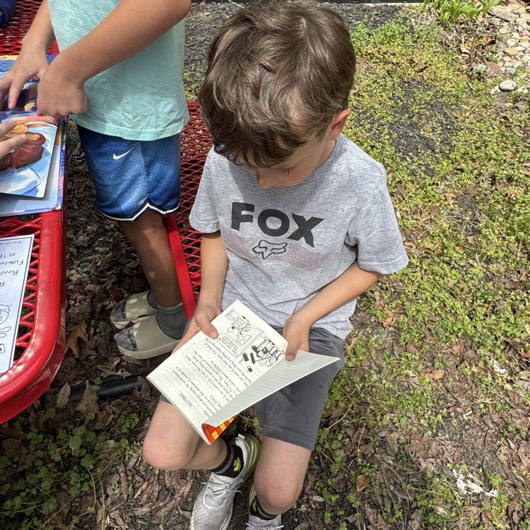 Mrs. Olsen’s class reading outside.