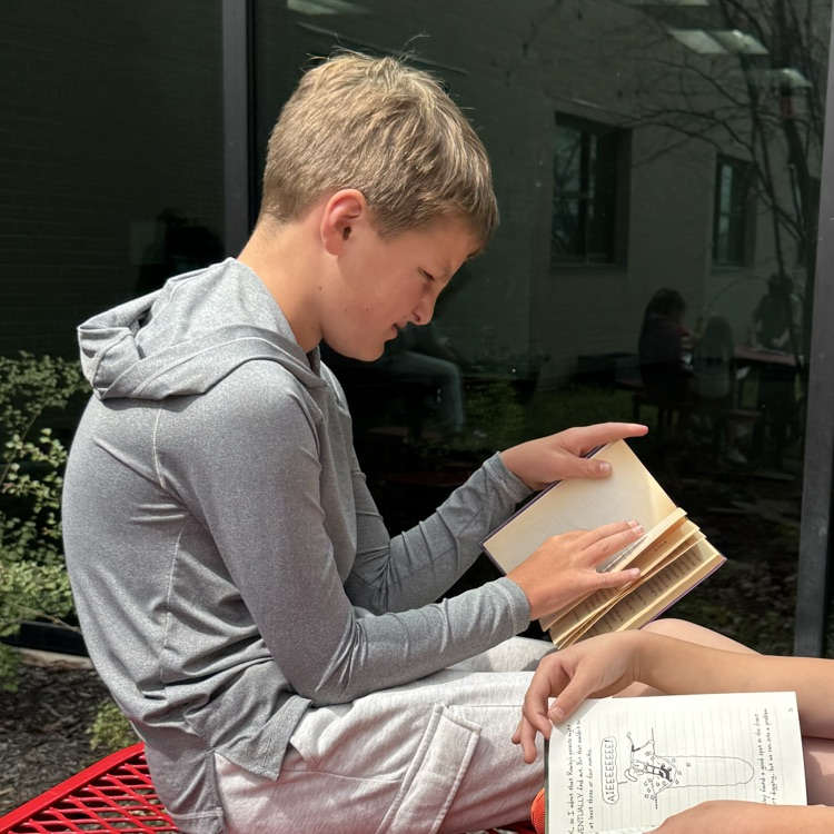Mrs. Olsen’s class reading outside.