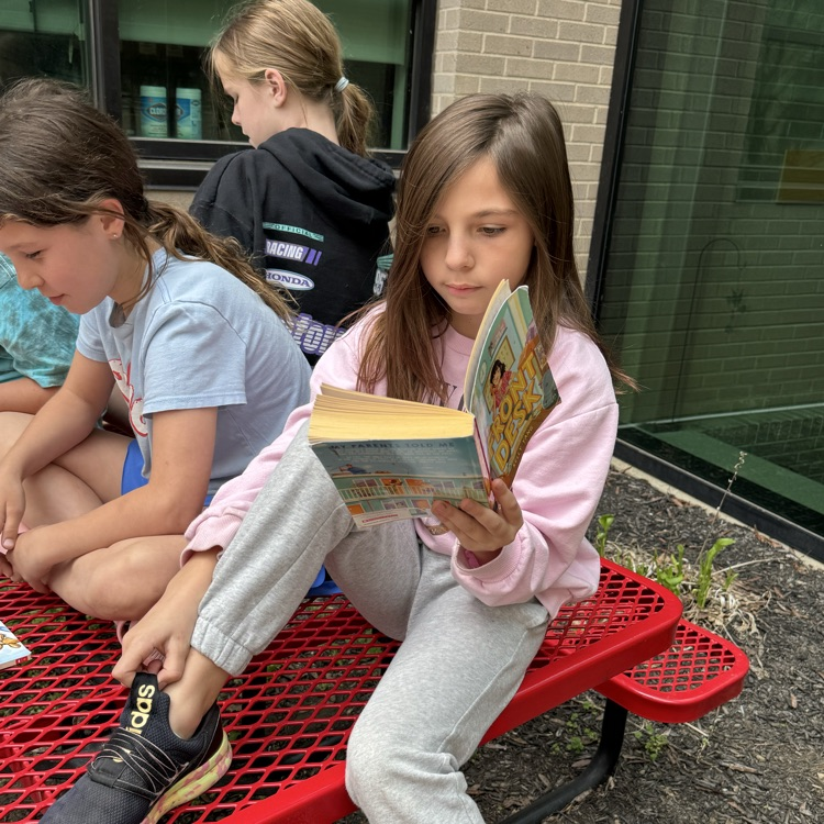 Mrs. Olsen’s class reading outside.