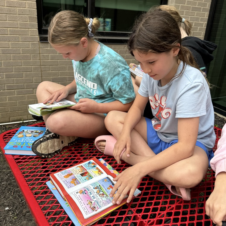 Mrs. Olsen’s class reading outside.