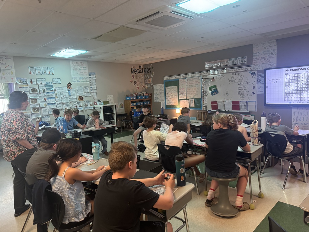 4th grade students in Mrs. Wolff's classroom prepare for upcoming state assessments by practicing their skills using a number grid.