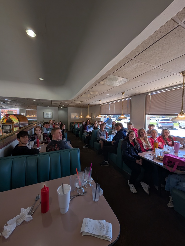 people sitting in booths at a restaurant