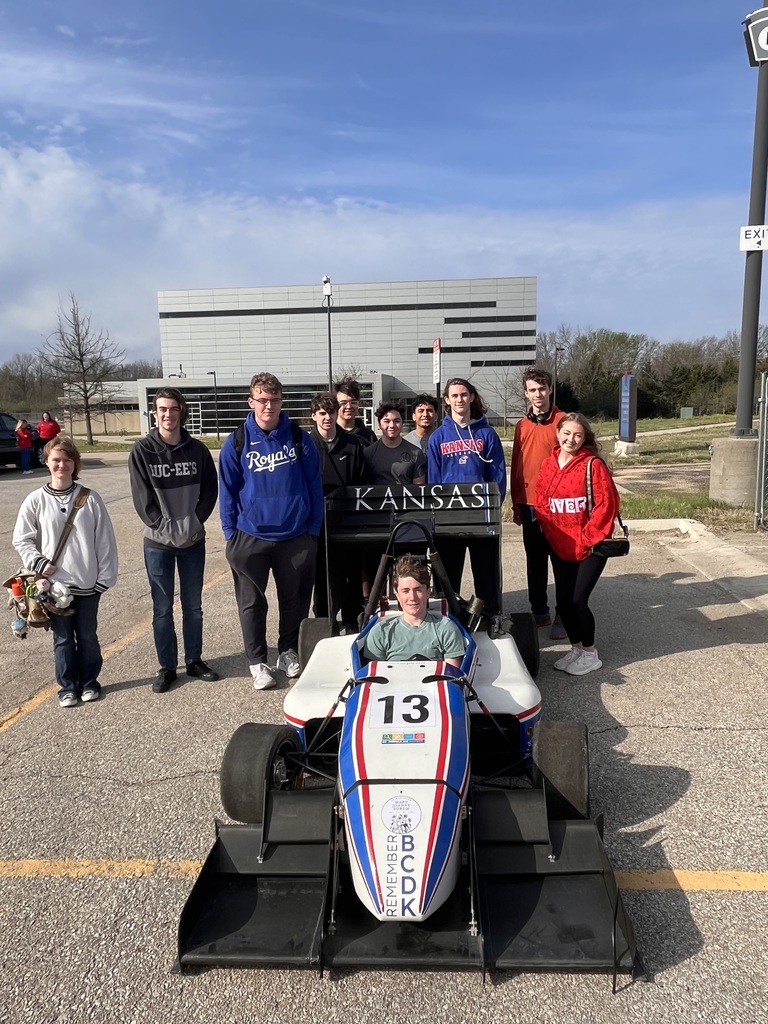 Engineering students with a formula one car.