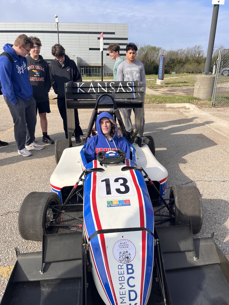 Engineering students with a formula one car.