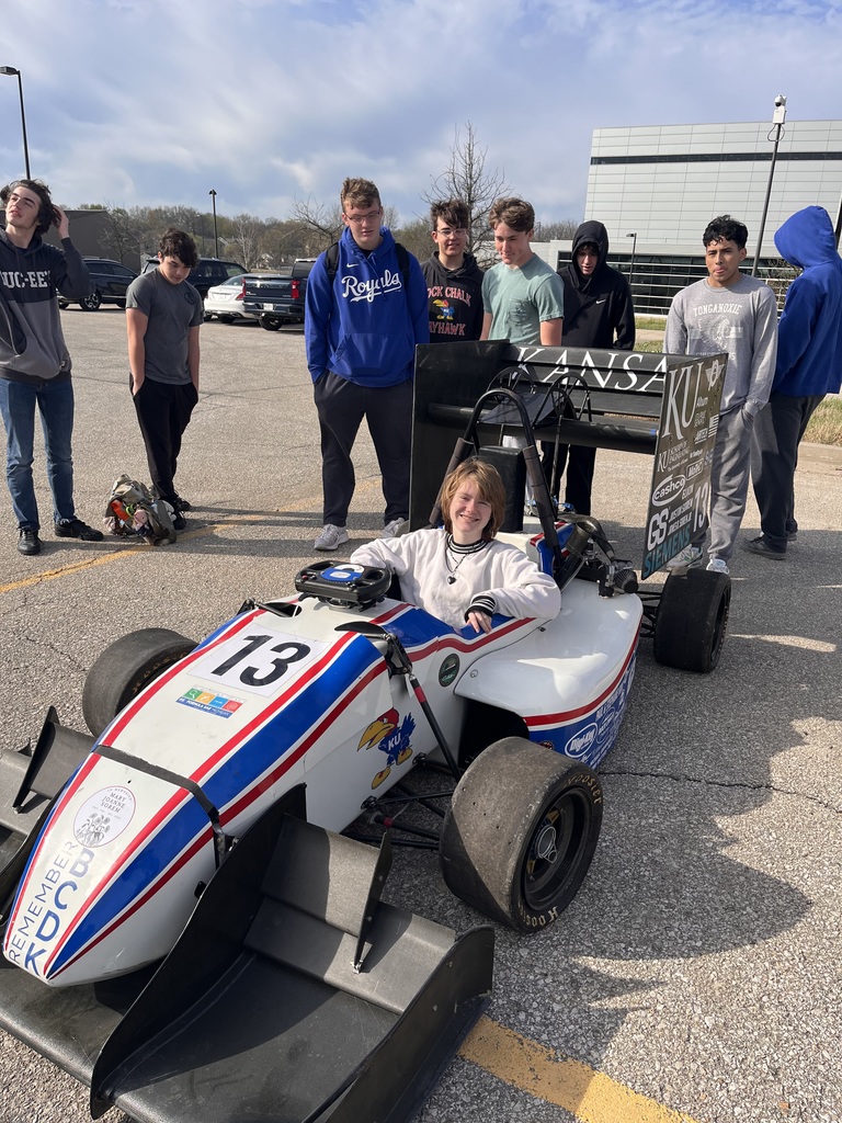 Engineering students with a formula one car.