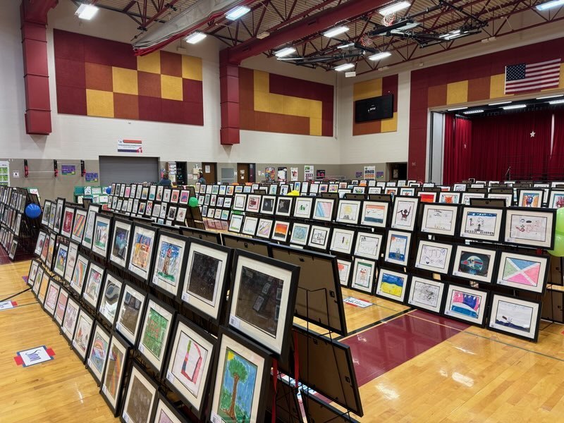 photo of framed art set up in gymnasium 