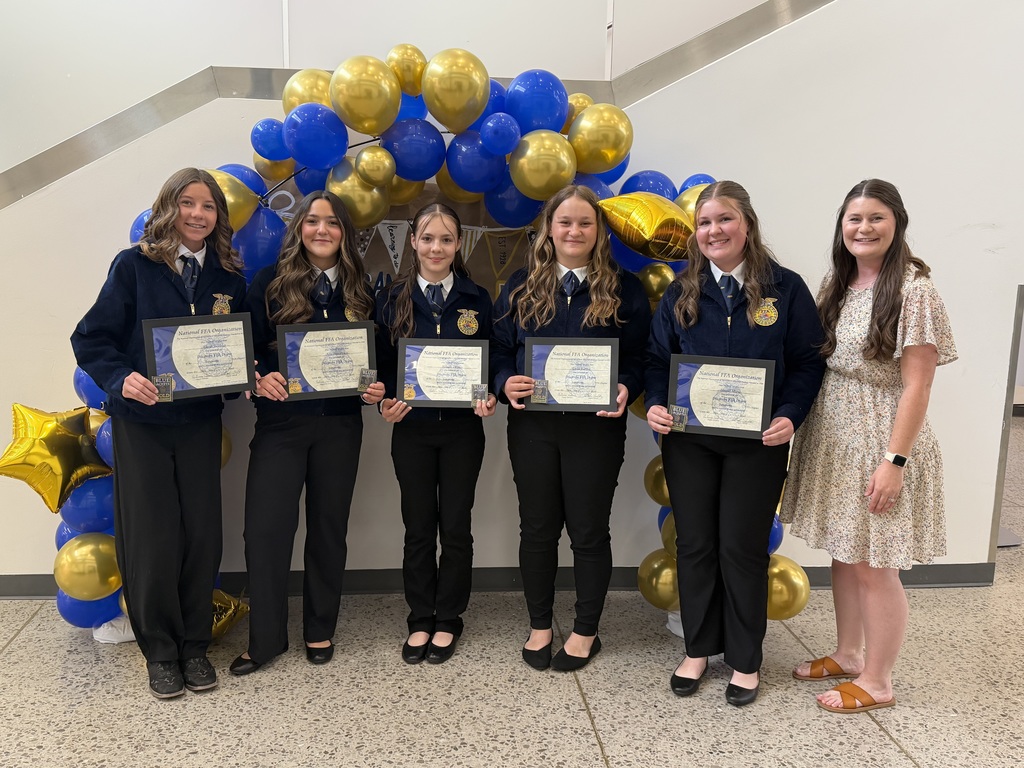 Group of five FFA members standing in front of a balloon arch