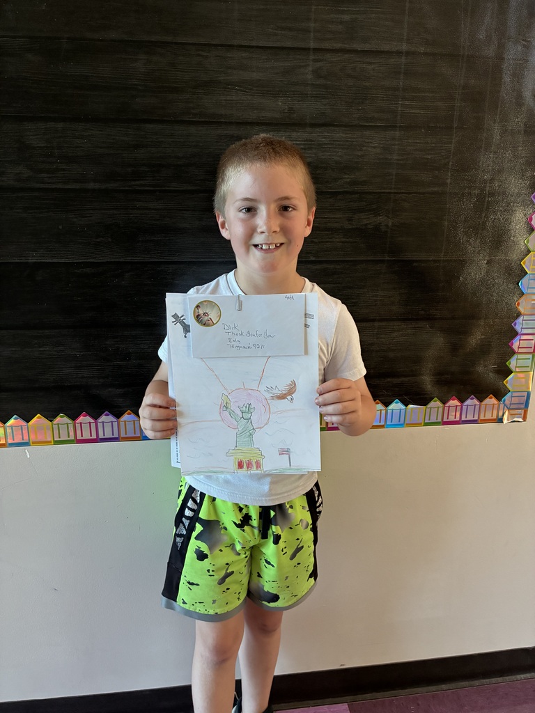 students holding artwork and certificates 