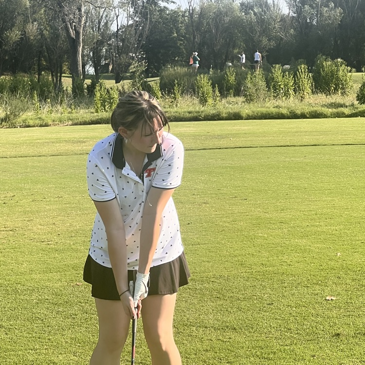 Emily hitting a wedge