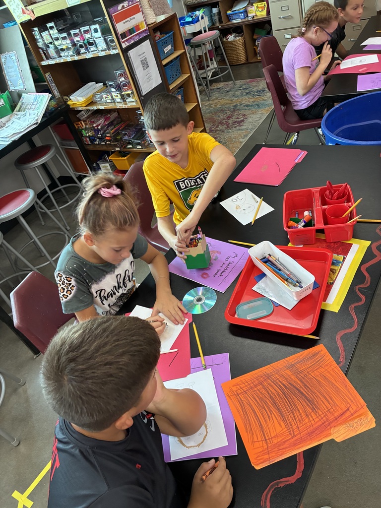three students drawing portraits 