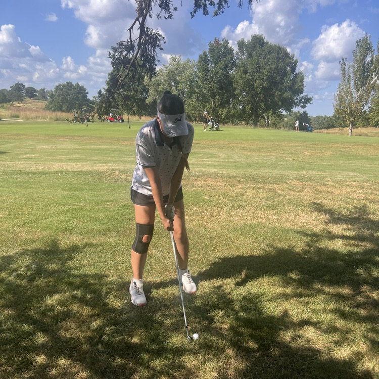 Audrey hitting a shot from a difficult position