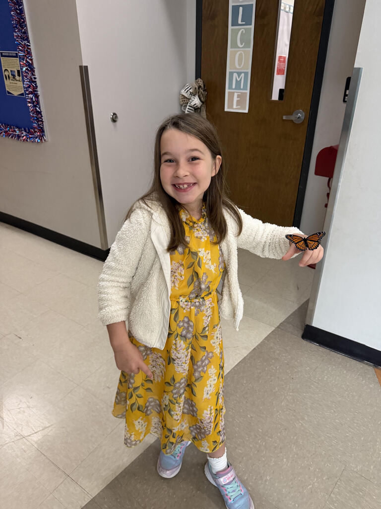 First grade student with monarch butterfly