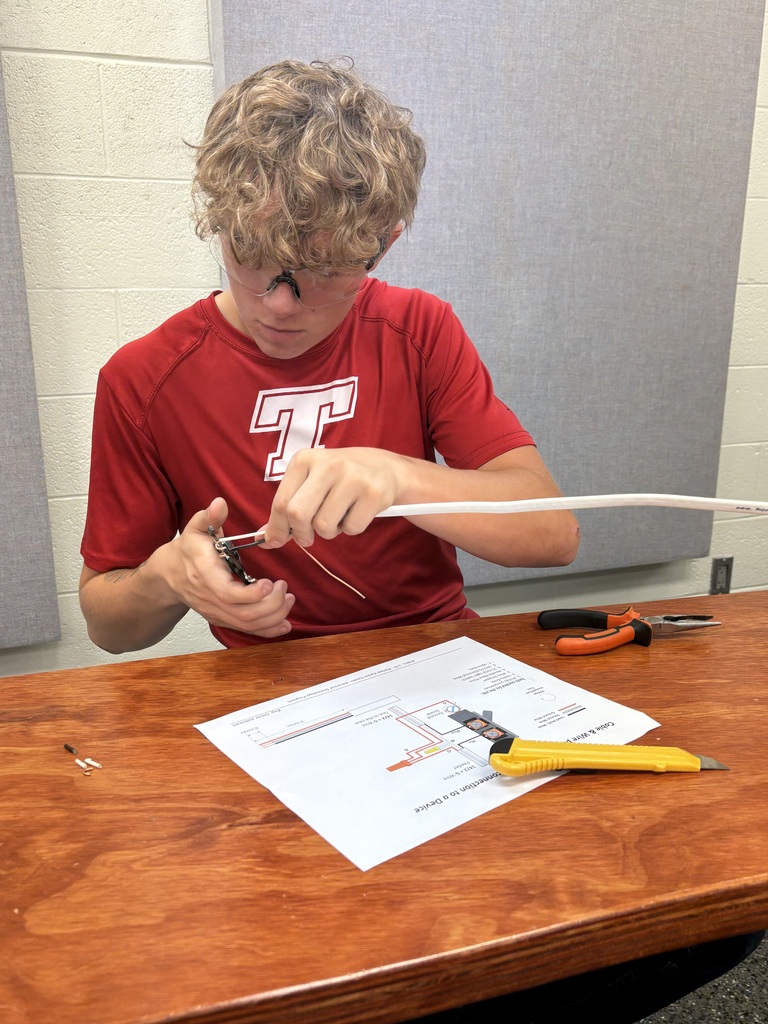 Student stripping wire at tech school.