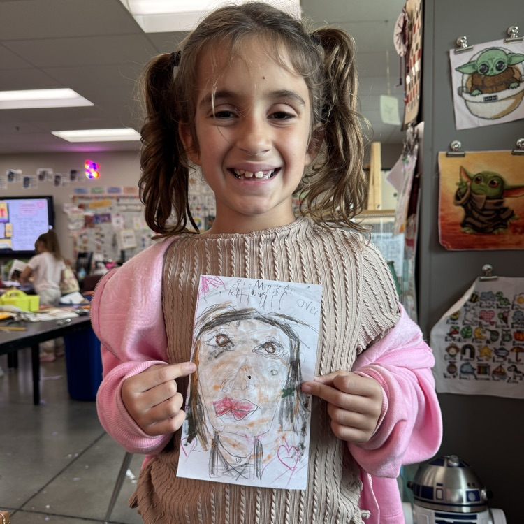 Rachel R. 2nd grade holding her self portrait