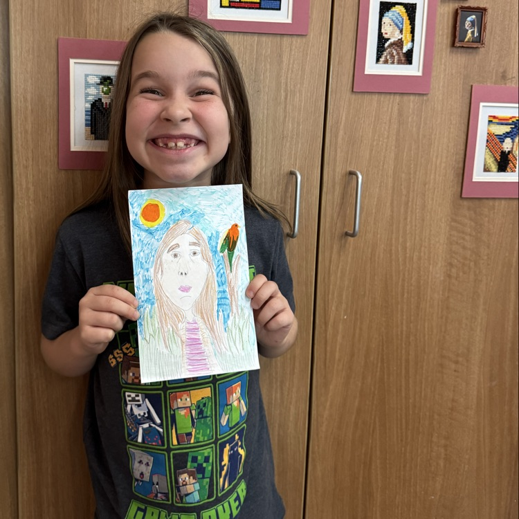 Bobeee Joe M. 1st grade holding her self portrait