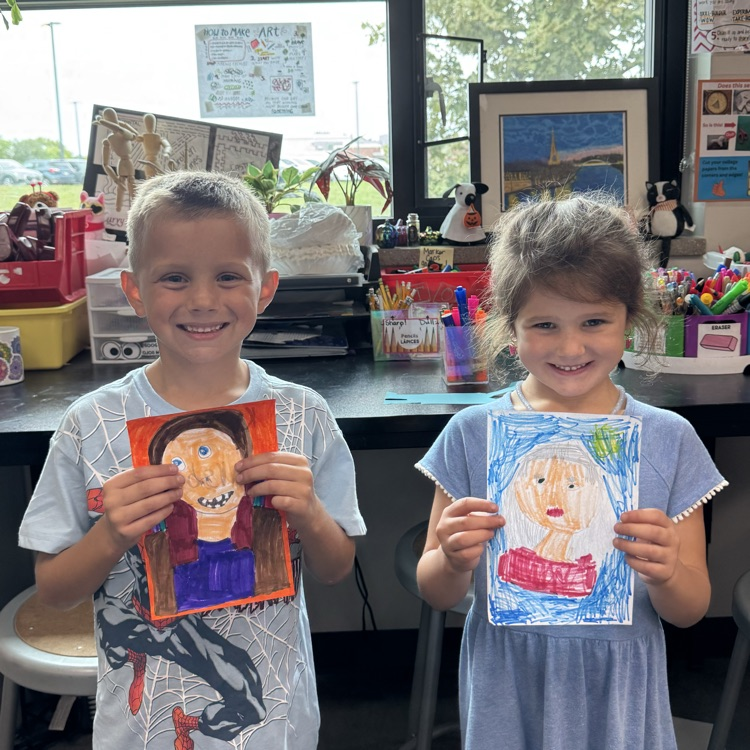 Grayson G. and McCoy B. Kindergarten holding her self portrait