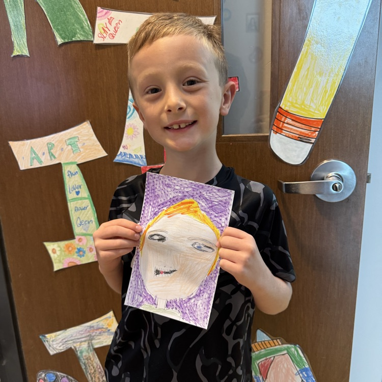 Nolan B. 2nd grade holding her self portrait
