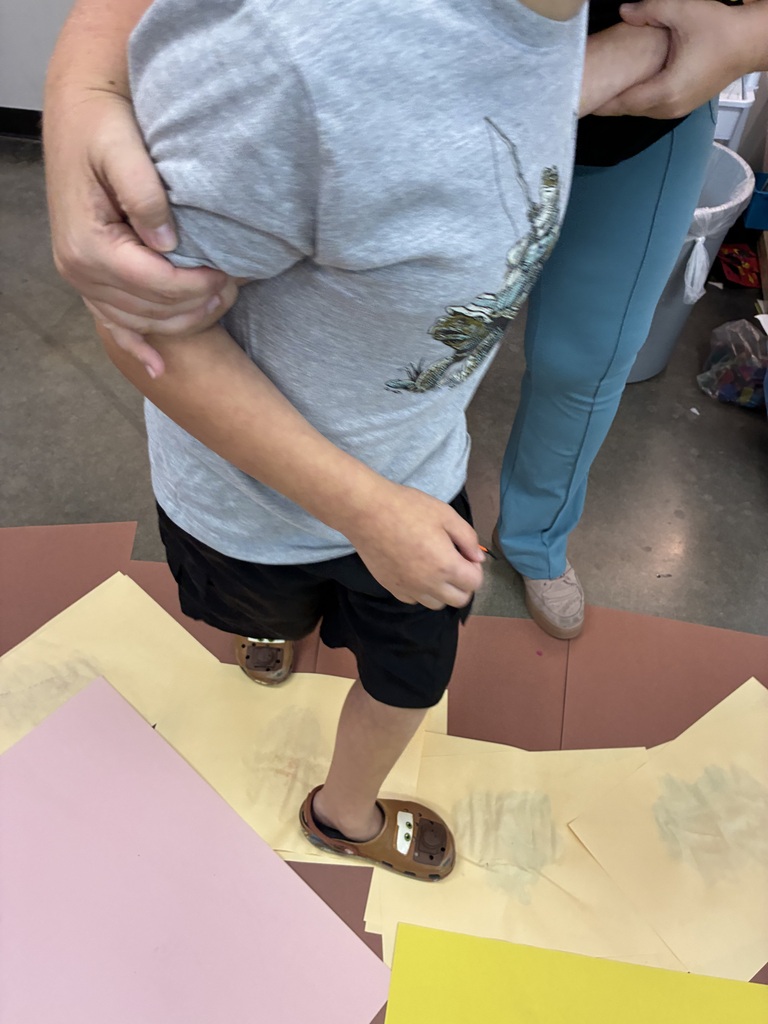 boy smoothing paint with his feet